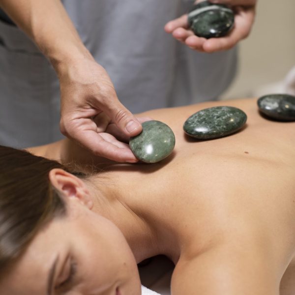 close-up-hands-holding-spa-stones
